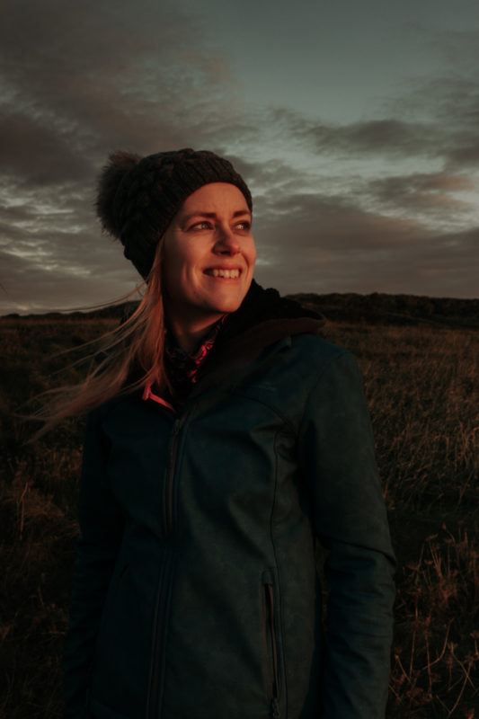 Girl staring into the sunrise wearing a Mountain Warehouse jacket.
