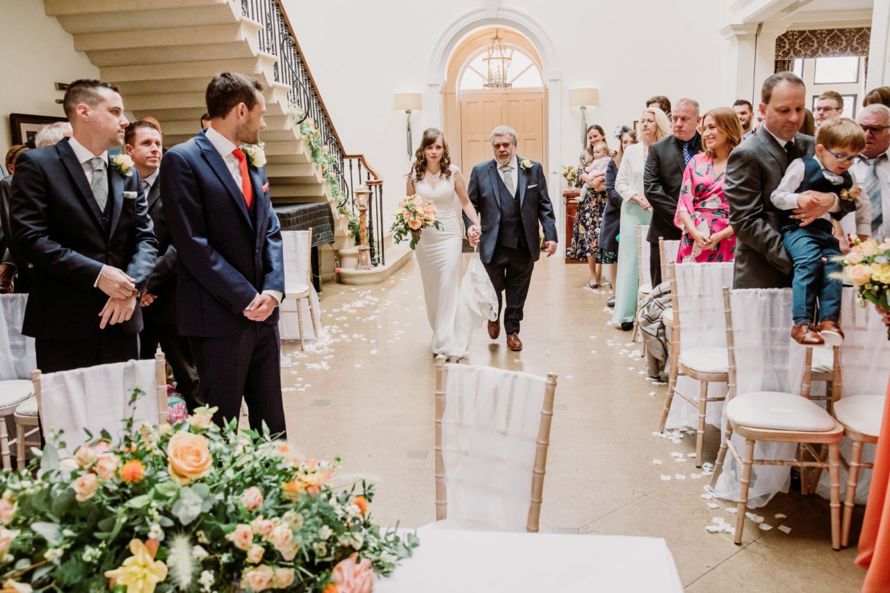 Donna being led down the aisle by her father