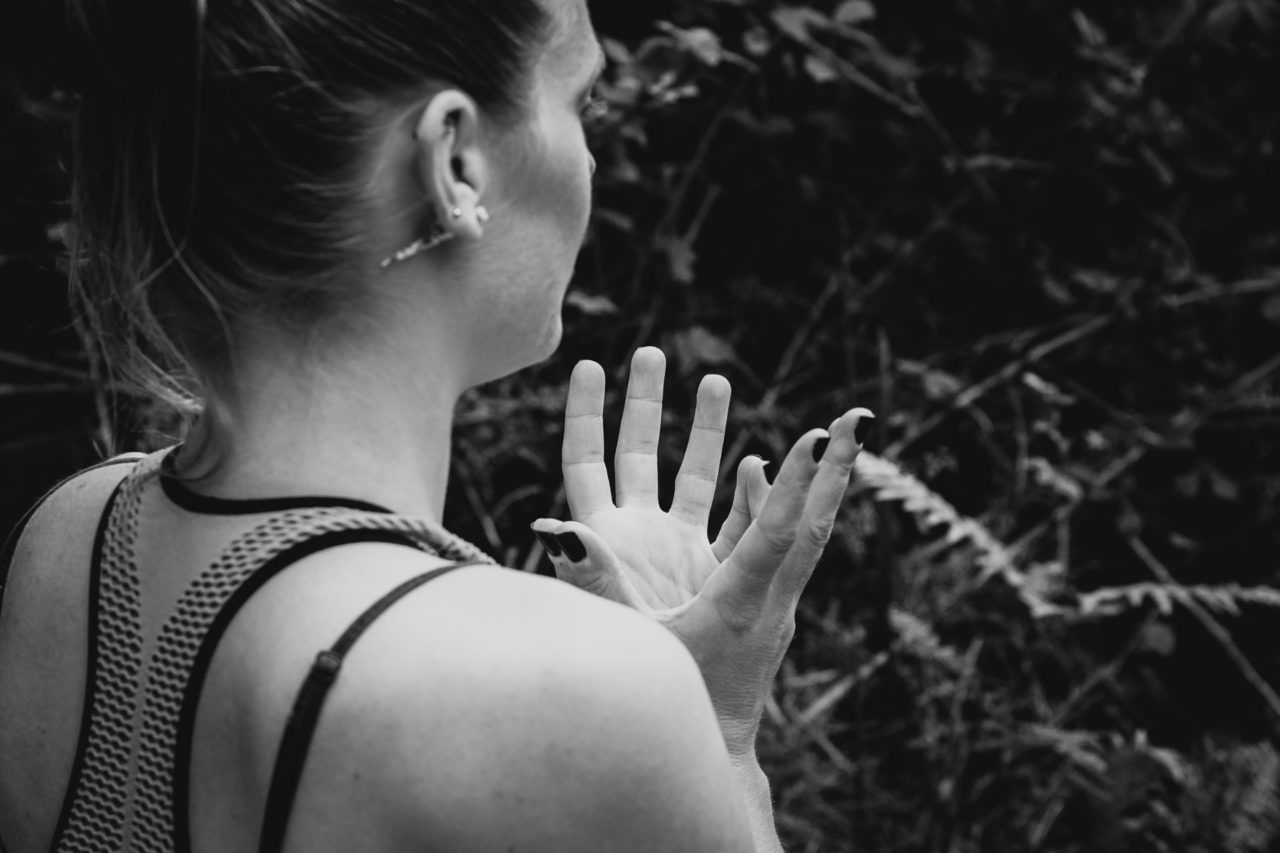 Black and white close up of girl's hands while meditating