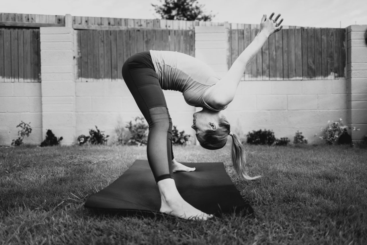 Girl bent down with arms above in black and white