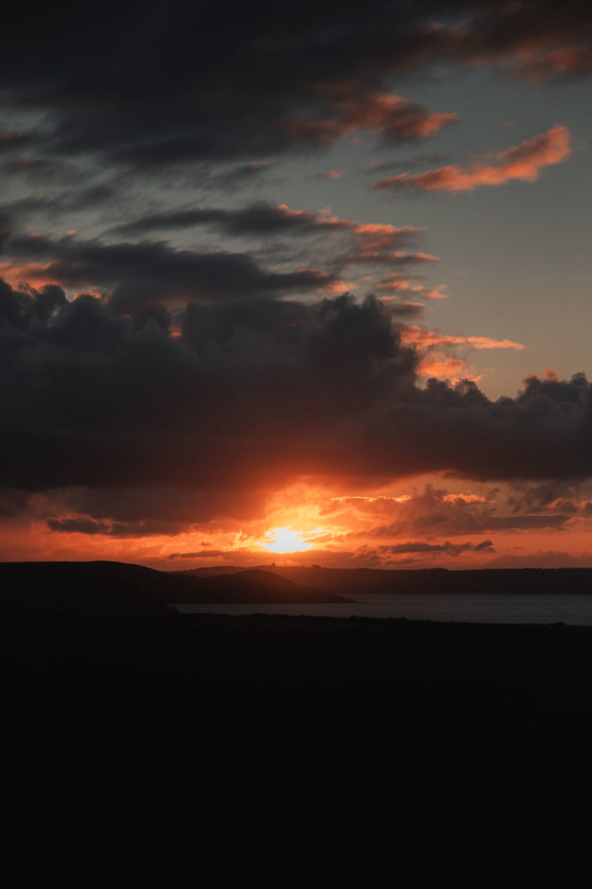 Sun piercing through the clouds as day breaks