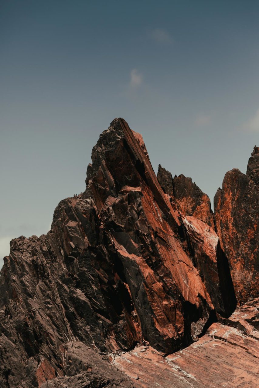 Red and orange rock formation stood against a blue sky