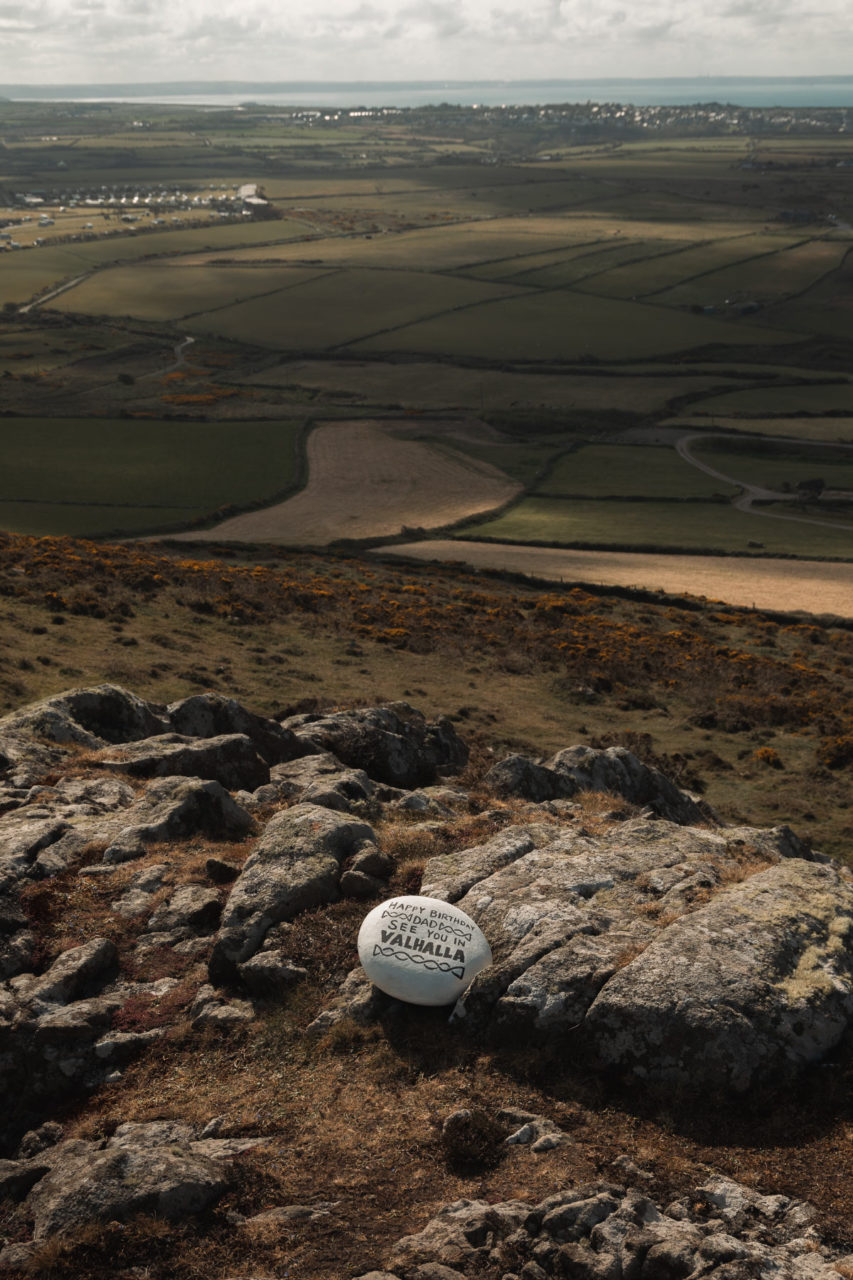 Rock at top of a mountain engraved with "Dad see you in Valhalla"