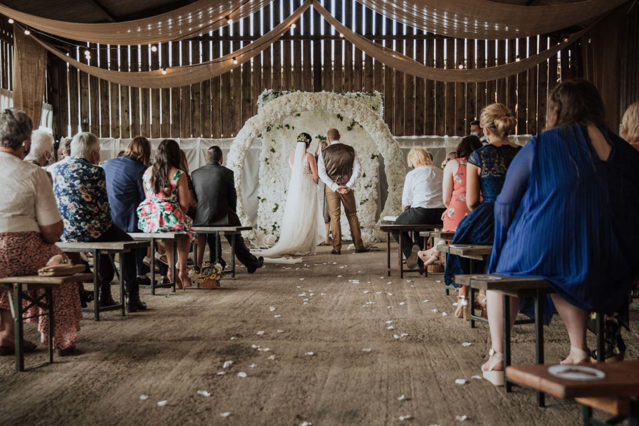 The back of a couple from the view down the aisle