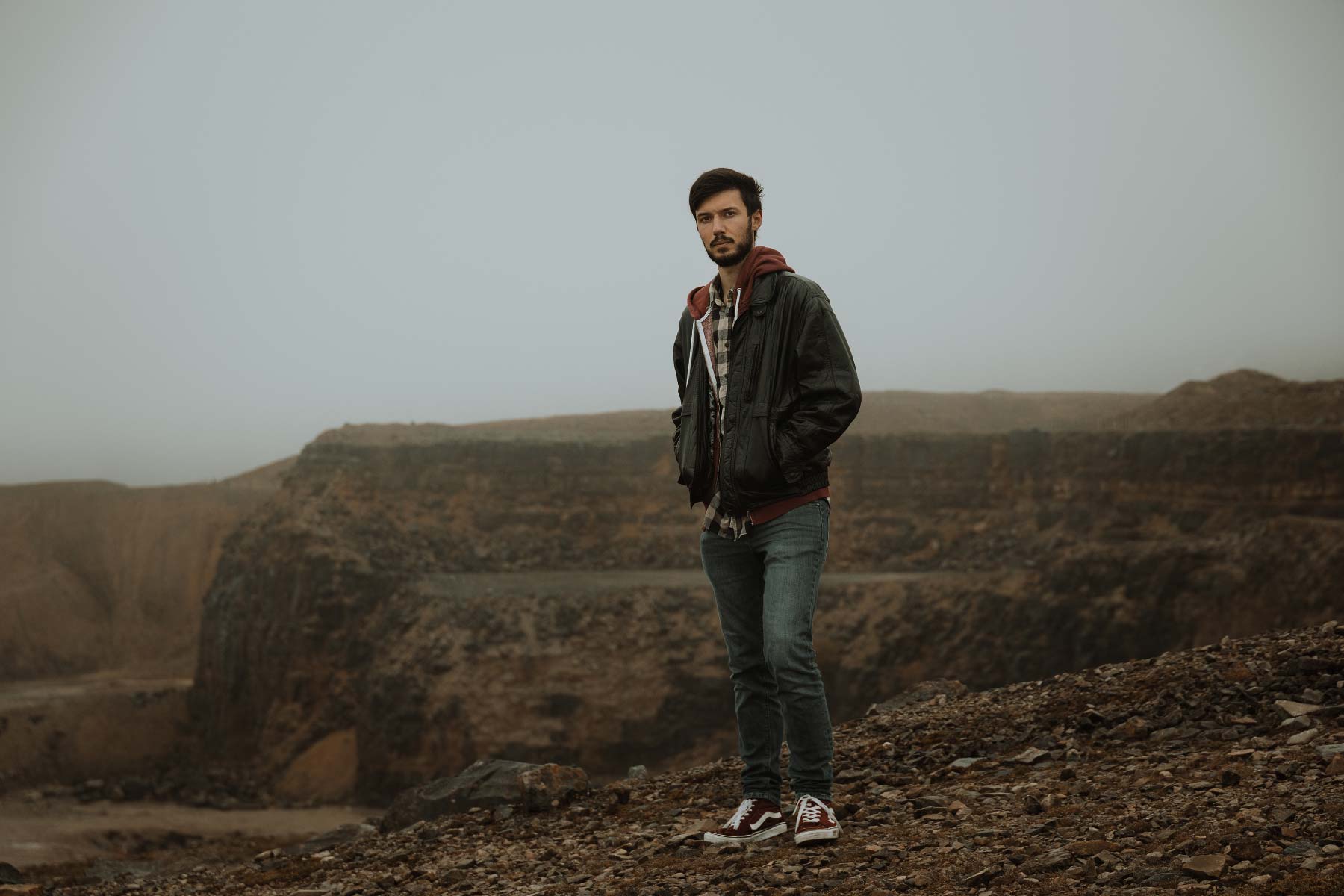 Man stood in front of an abandoned Welsh quarry in the mist