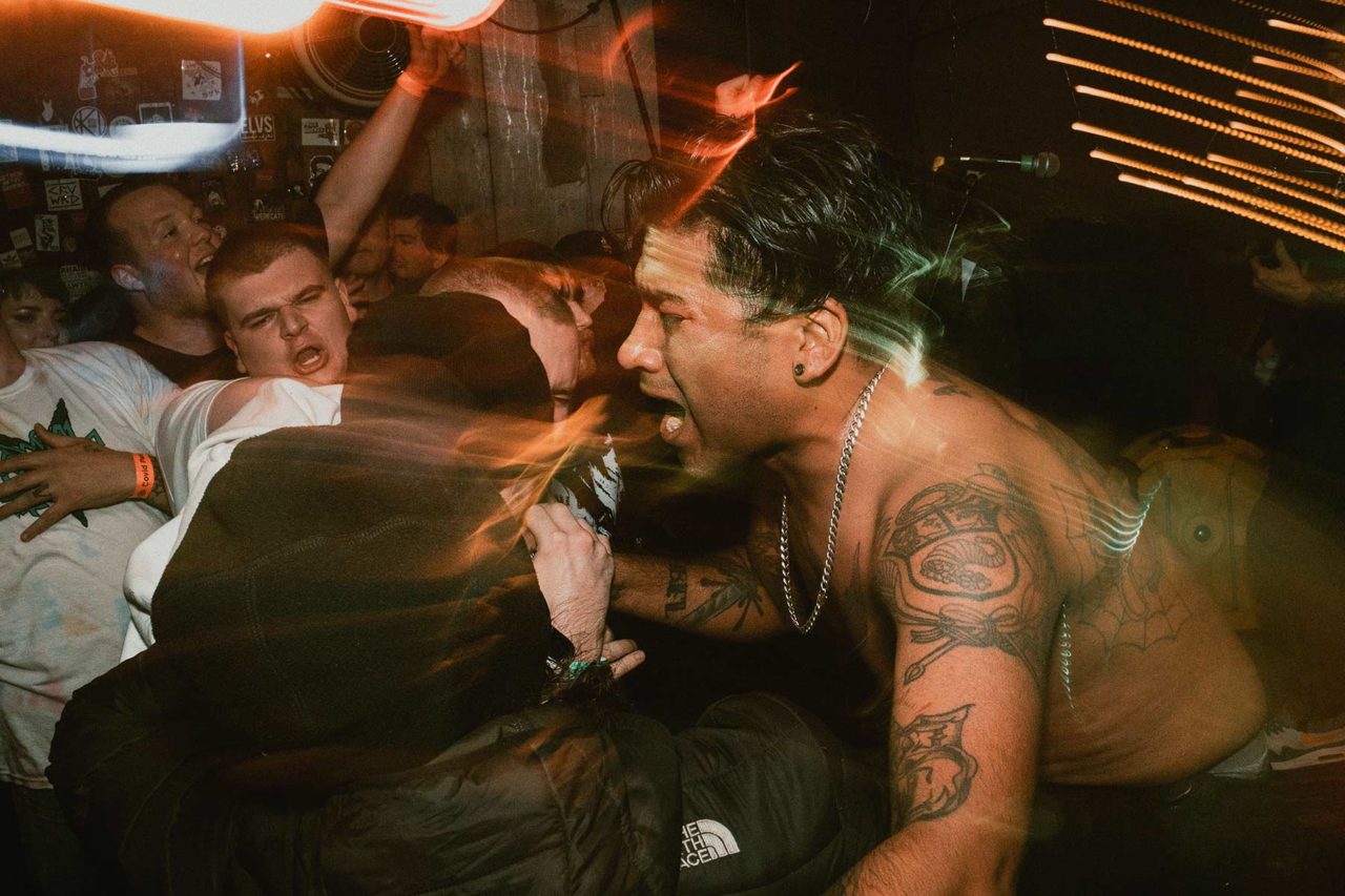 Vocalist screaming into fans face with motion blur
