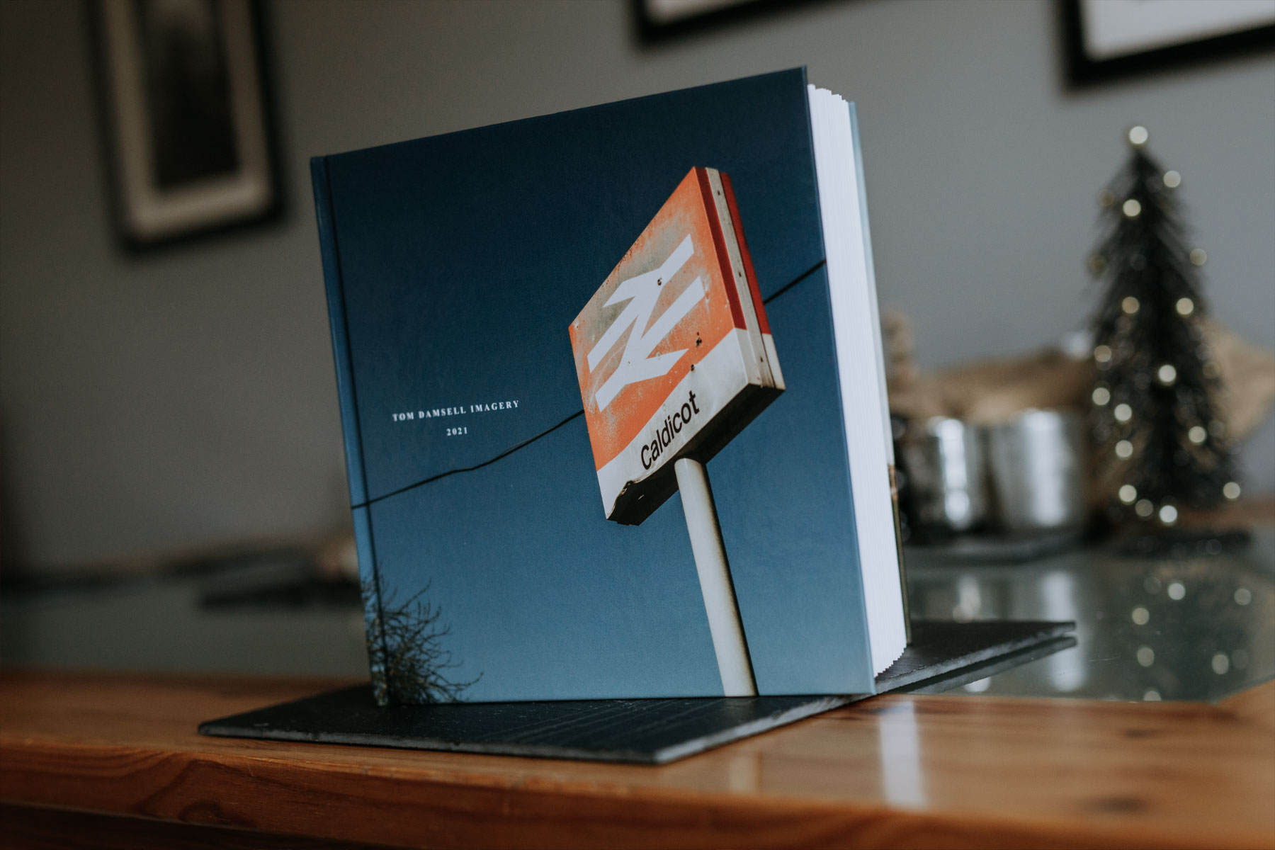 The front cover of a book stood on a table with a Caldicot Nation Rail sign on the front