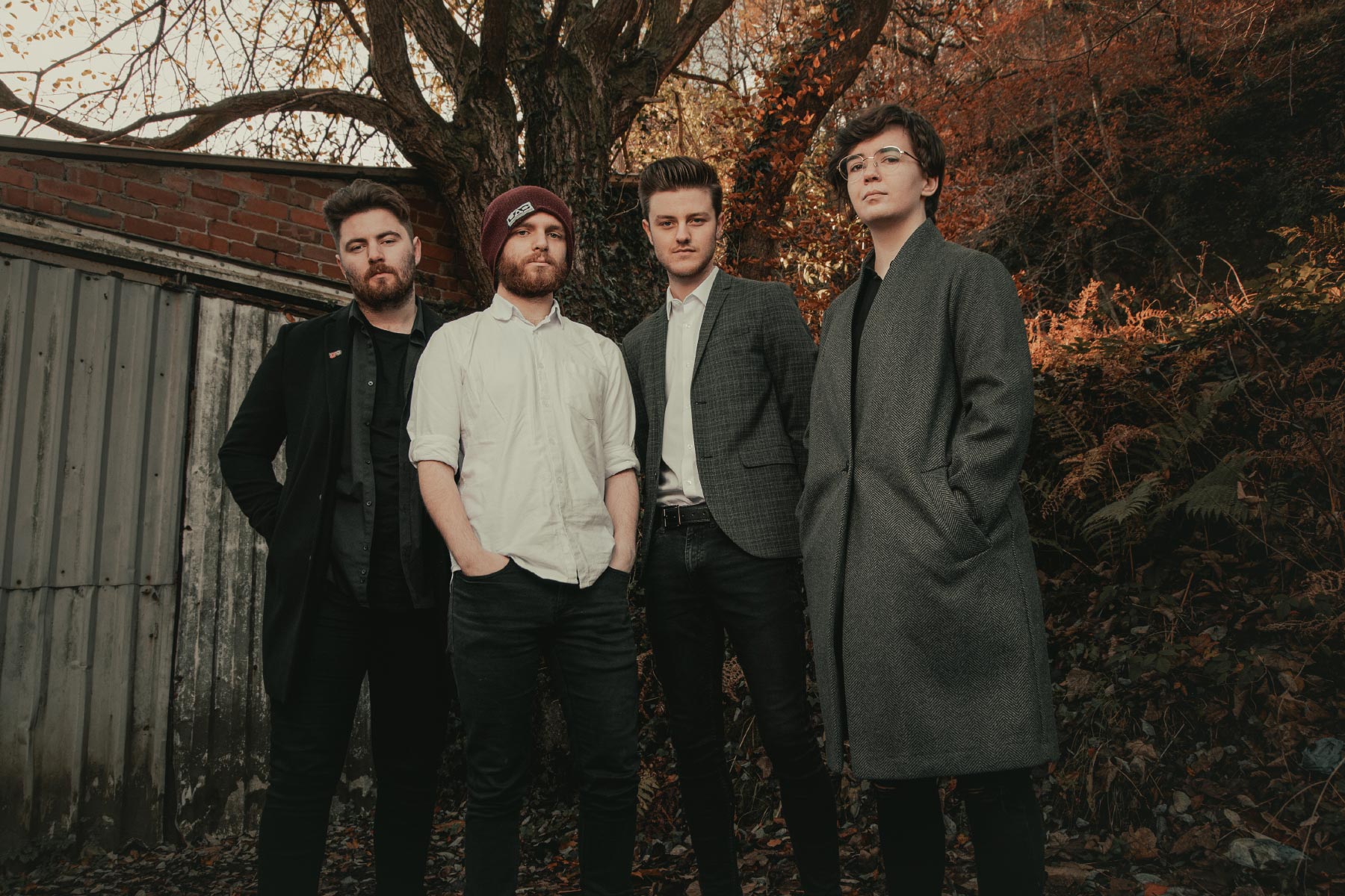 Female fronted band stood dressed in smart attire