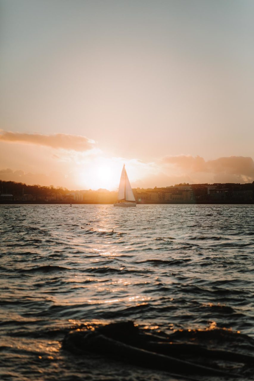 Sailing boat caught by the light of the setting sun