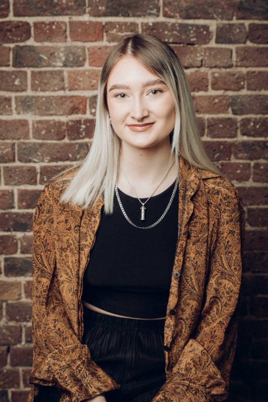 Young woman woman smiling to the camera during a studio shoot