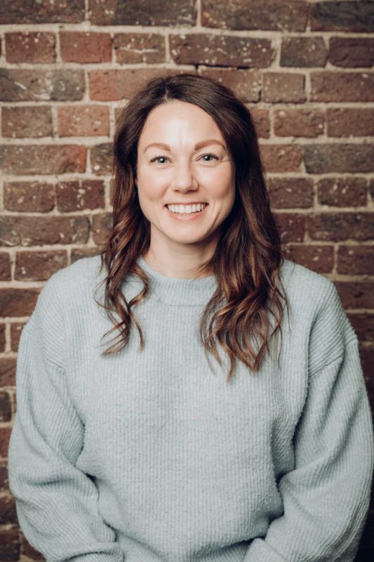 Smiling woman staring into to the camera during a studio shoot