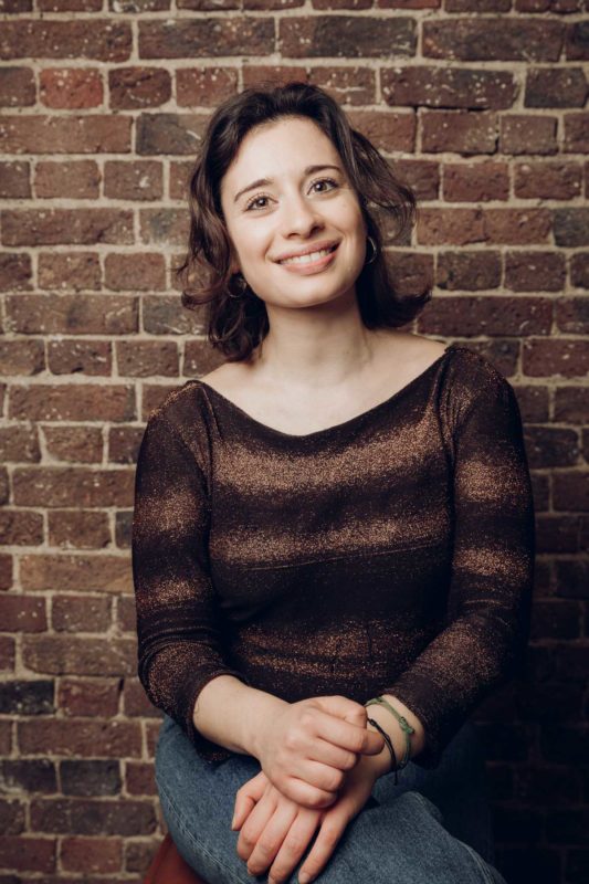 Happy looking woman smiling to the camera during a studio shoot