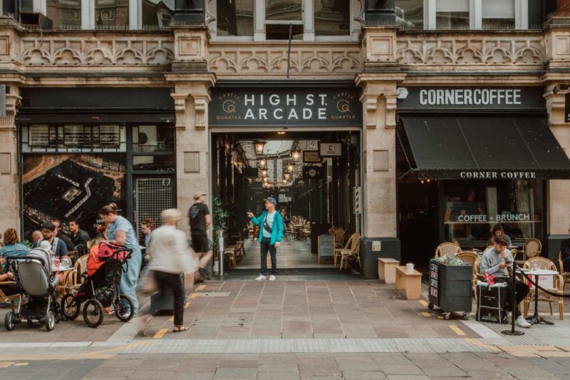 The front of High Street Arcade in Cardiff with people walking past