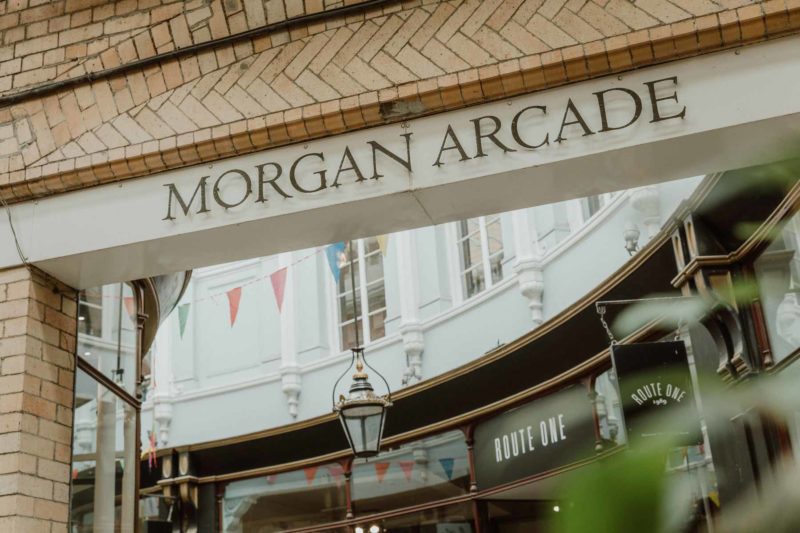 Abstract shot of the Morgan Arcade sign taken through some greenery, giving a sense of depth