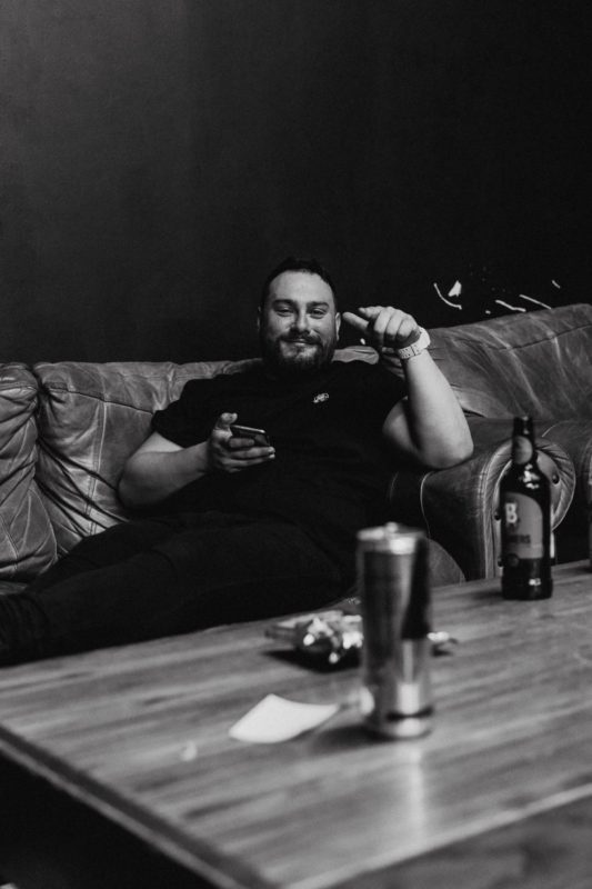 Black and White shot of band member sat backstage in Cardiff 