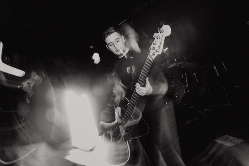 Bass player from De'Lour playing on stage in Brighton