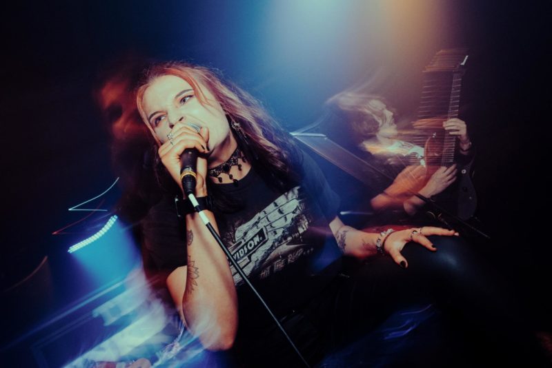 Bethany O'Mahoney singning into the camera with motion blur