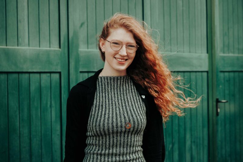 Smiley portrait of a female Loom Digital employee. Shout outside Temple Gate, Bristol.